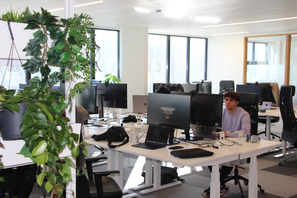 Office workspace with attendees collaborating during a session.