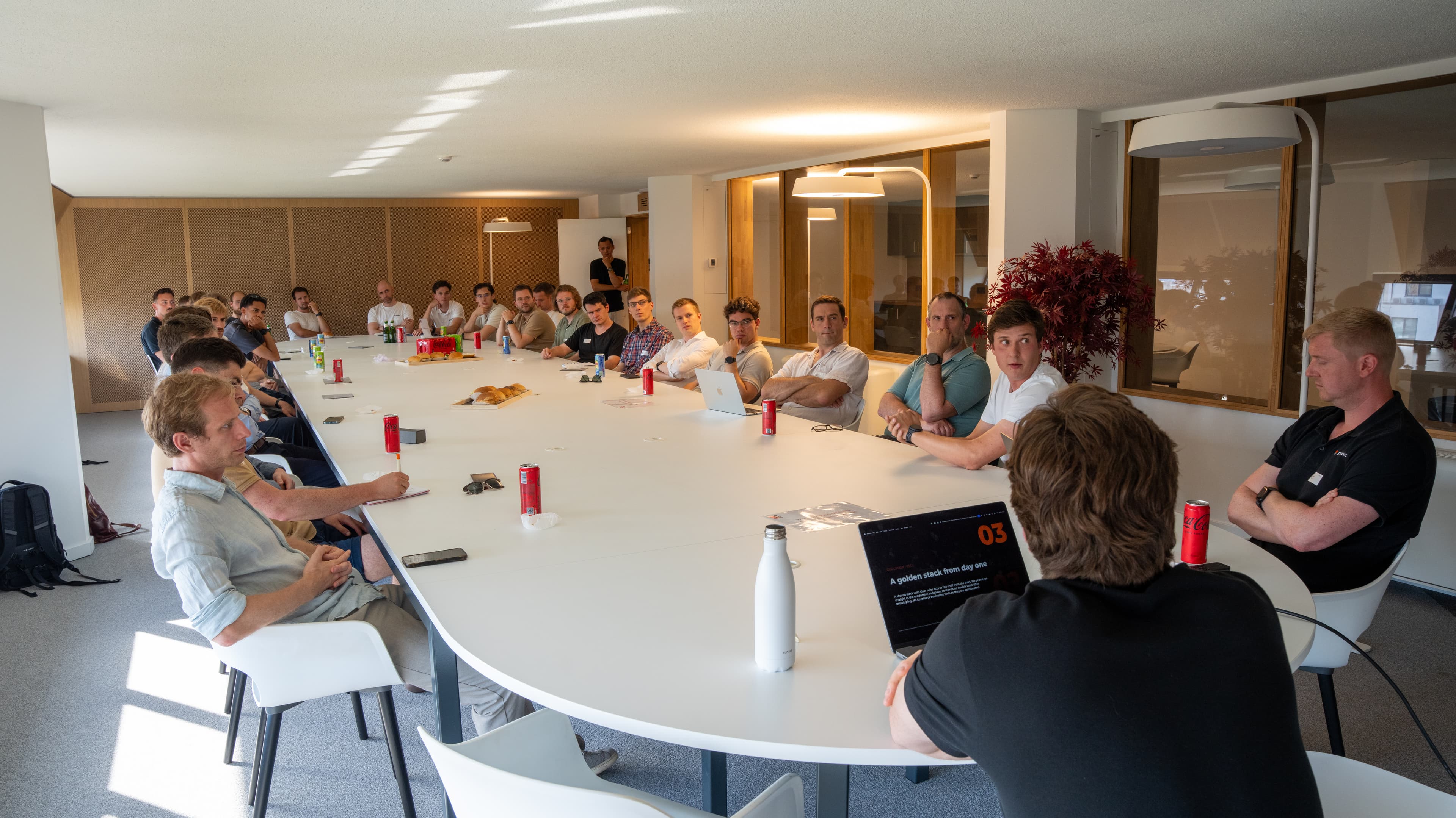 Full group seated around a large roundtable during the evening session.