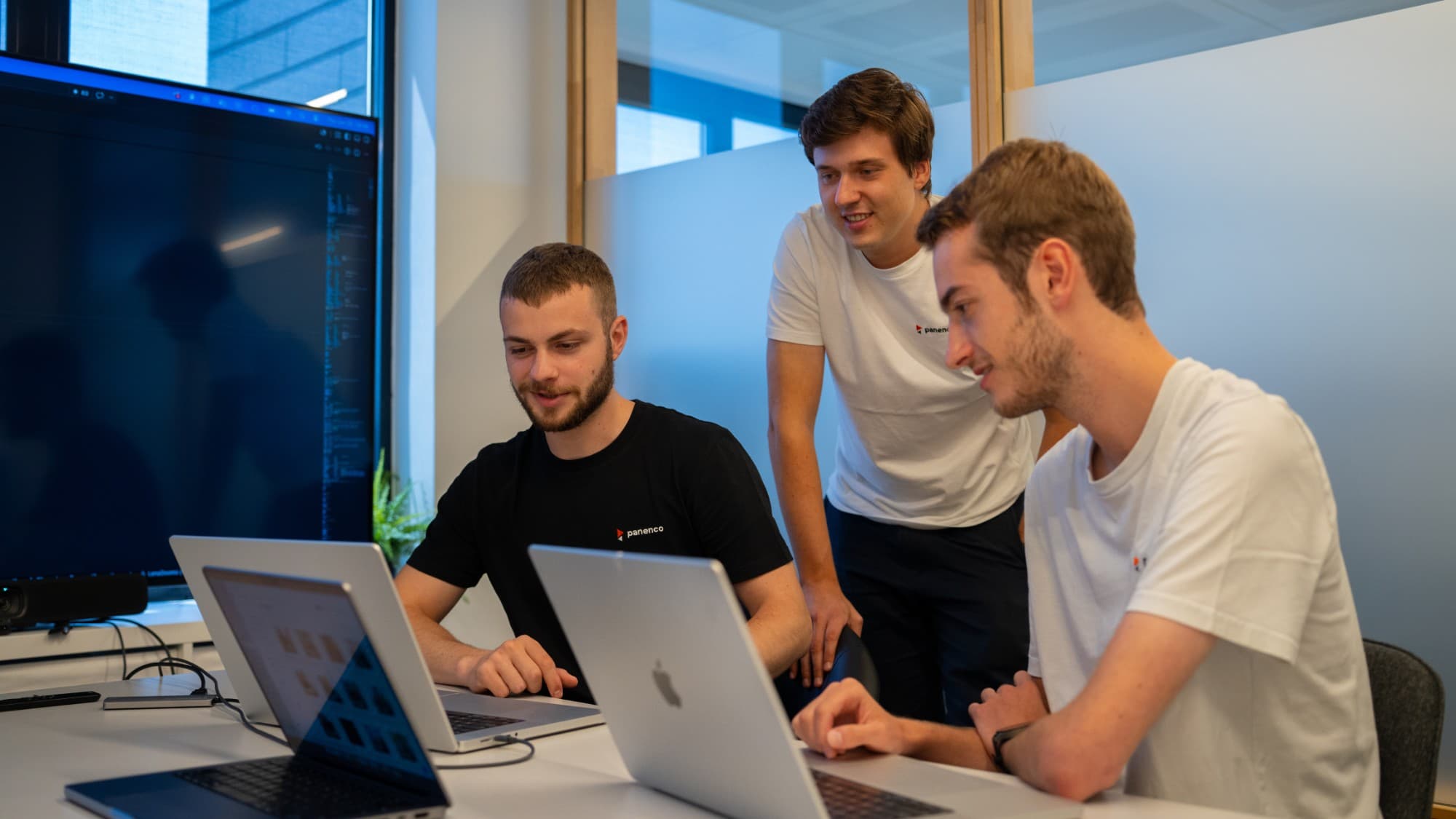 Panenco engineers collaborating on laptops